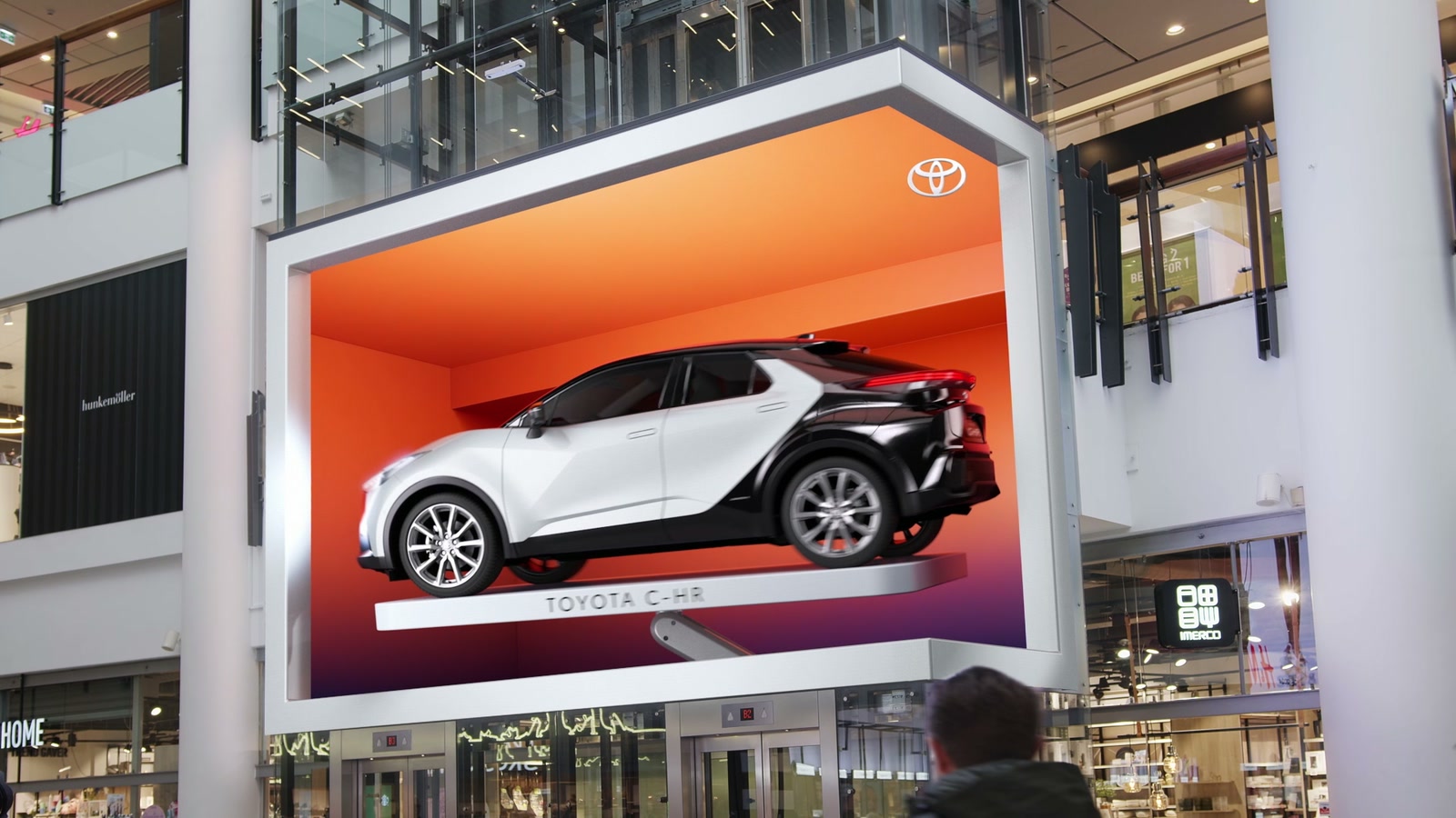 White Toyota C-HR in a glowing orange three-dimensional billboard